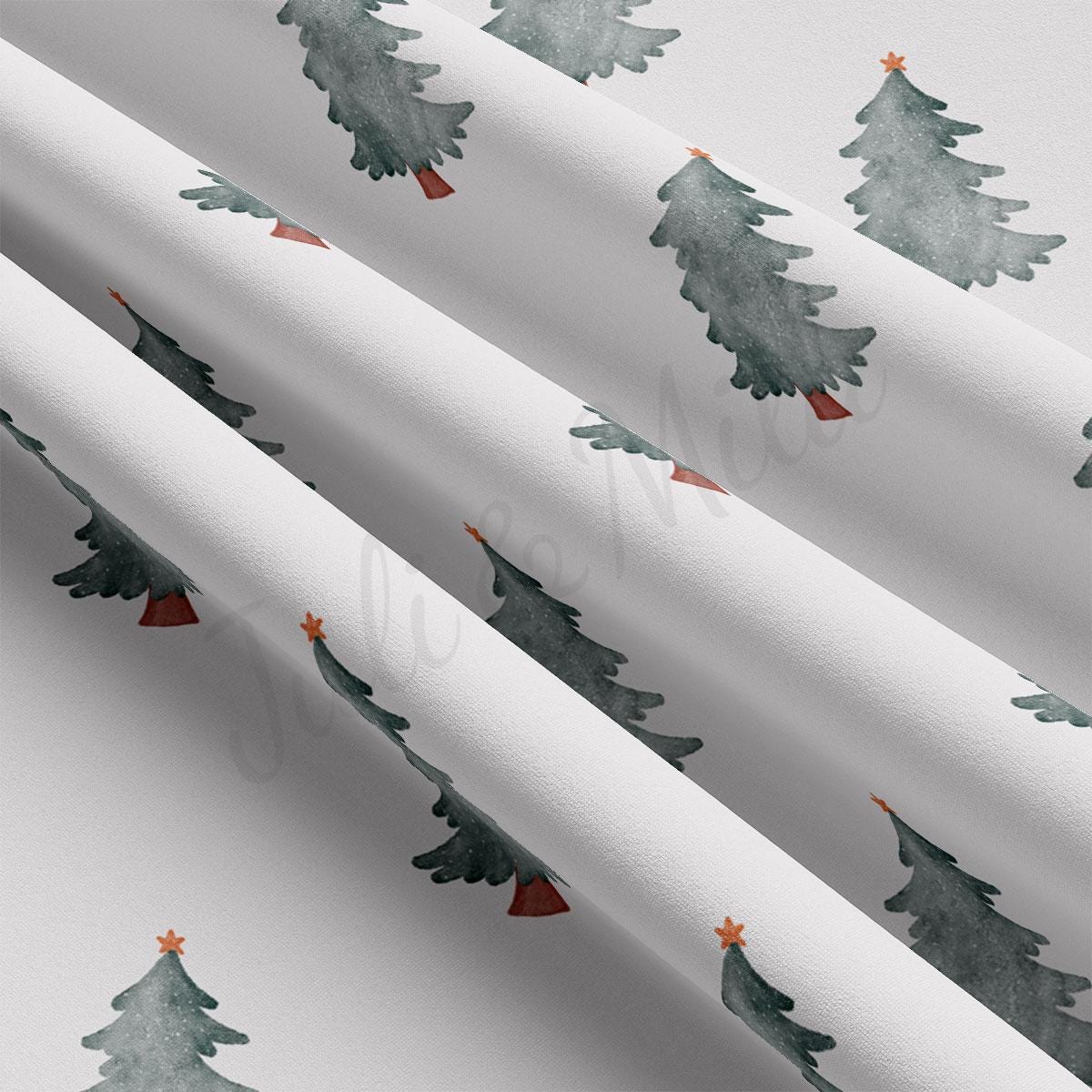 a close up of a wrapping paper with christmas trees on it