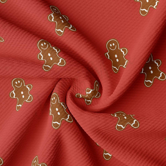 a close up of a red fabric with ginger cookies on it