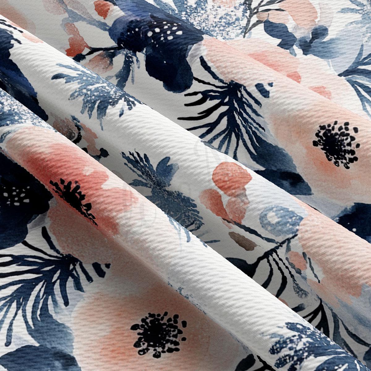 a close-up view of a fabric with a floral pattern in shades of blue, pink, and white. The fabric appears to be made of a soft, textured material, and the pattern is intricate and detailed.