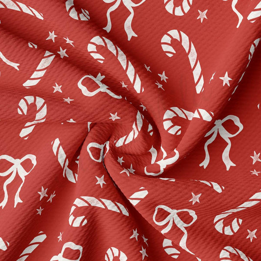 a red fabric with white christmas decorations on it