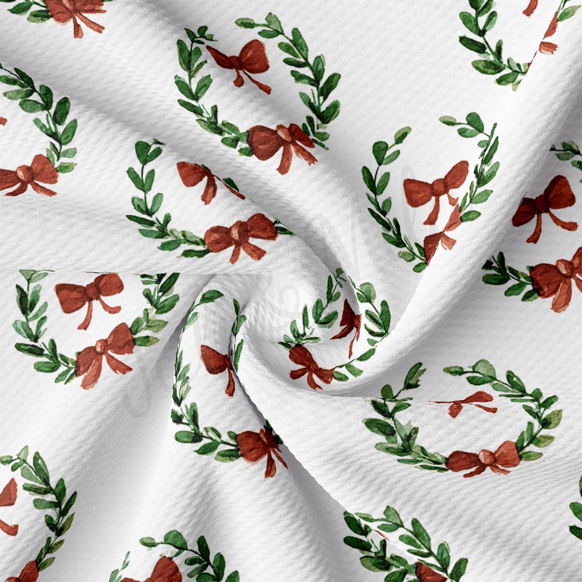 a close-up view of a fabric with a repeating pattern of green leaves and red bows.
