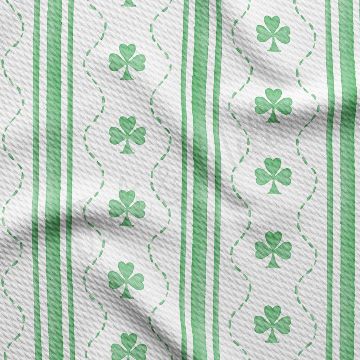a green and white striped fabric with shamrocks on it