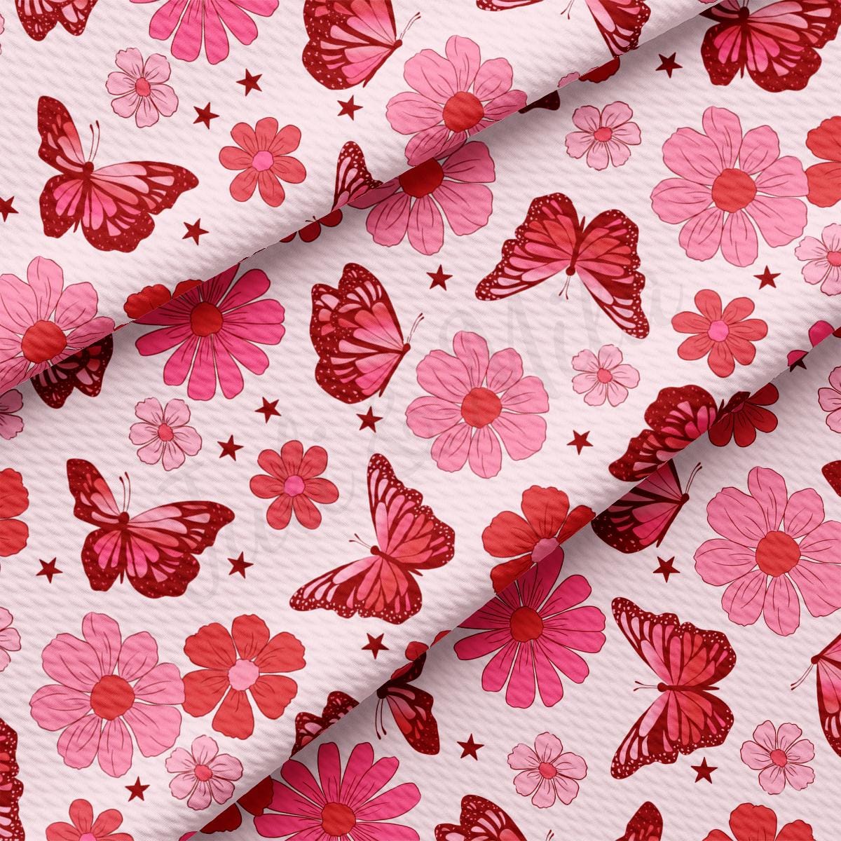 a pink and red flower and butterfly print fabric