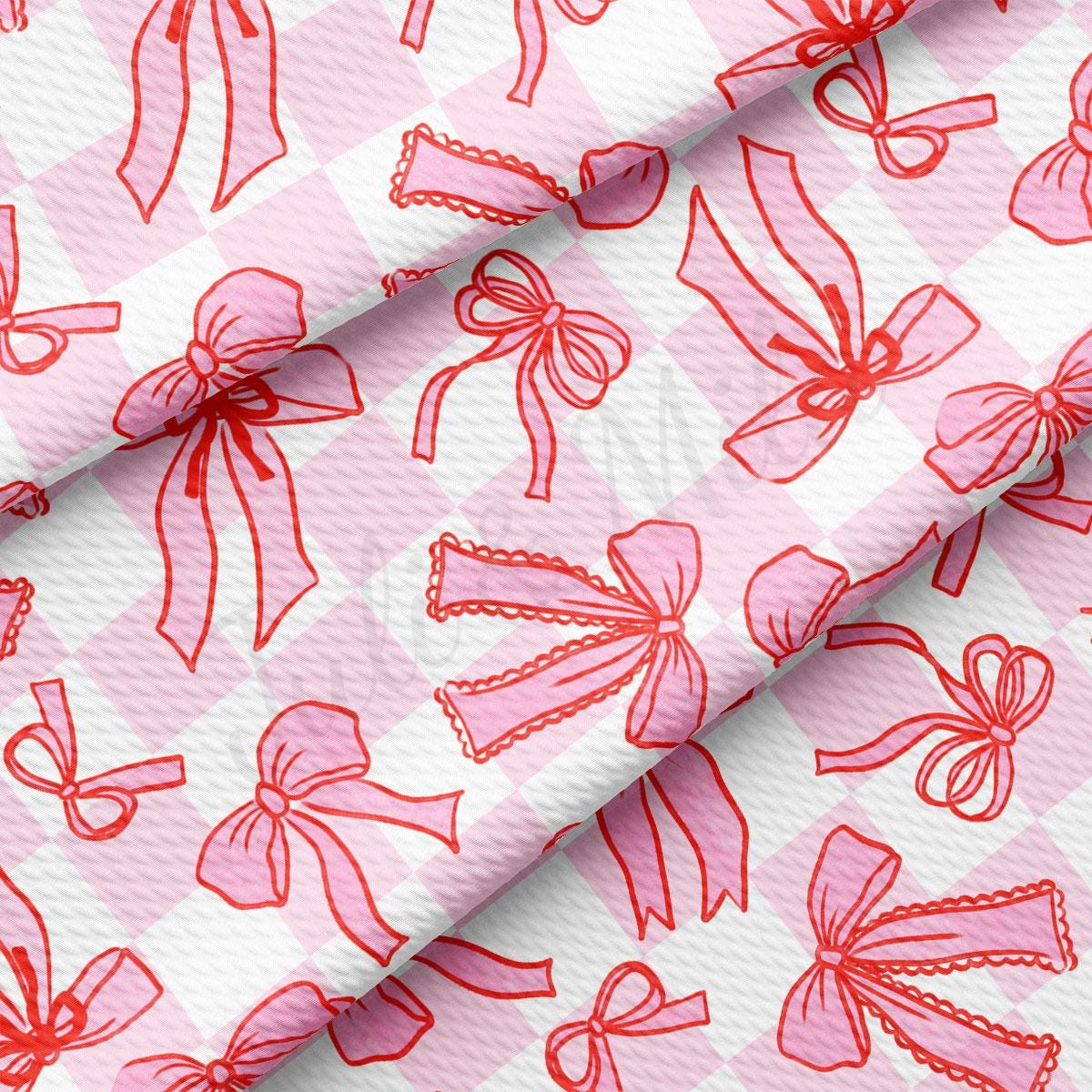 a pink and white checkered fabric with bows