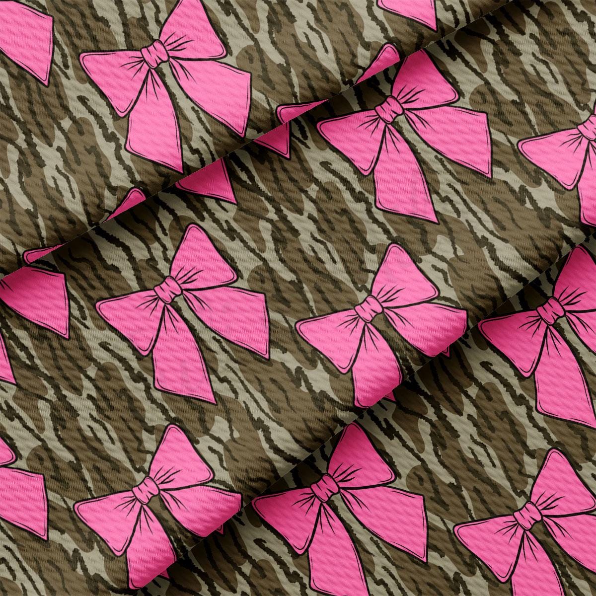 a pattern of pink bows on a brown background