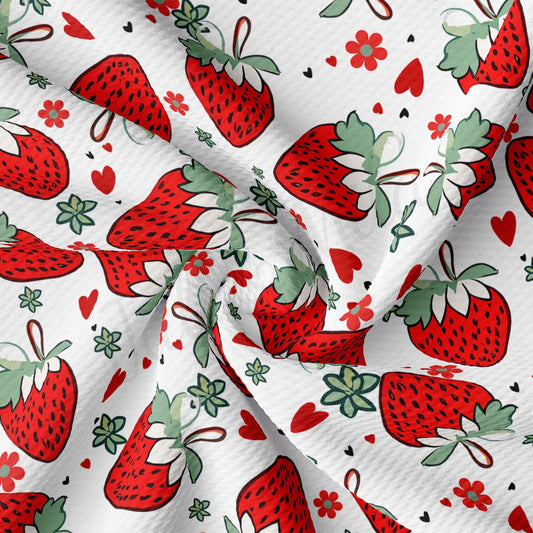 a close-up view of a fabric with a repeating pattern of red strawberries and green leaves. The pattern is composed of multiple strawberry images, each with a unique arrangement of leaves and stems. The fabric appears to be made of a soft, white material, and the overall composition is visually appealing and vibrant.