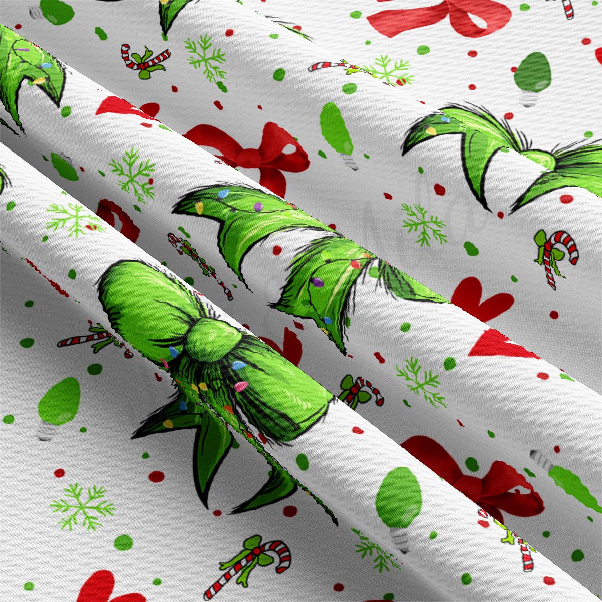 The image is a close-up of a fabric with a repeating pattern of green and red Christmas-themed elements, including green bows, red ribbons, snowflakes, and candy canes.