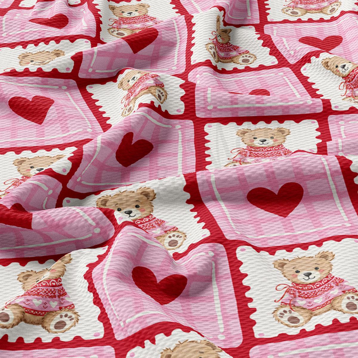The image is a close-up of a fabric with a repeating pattern of pink and white teddy bears wearing red sweaters, along with red hearts.