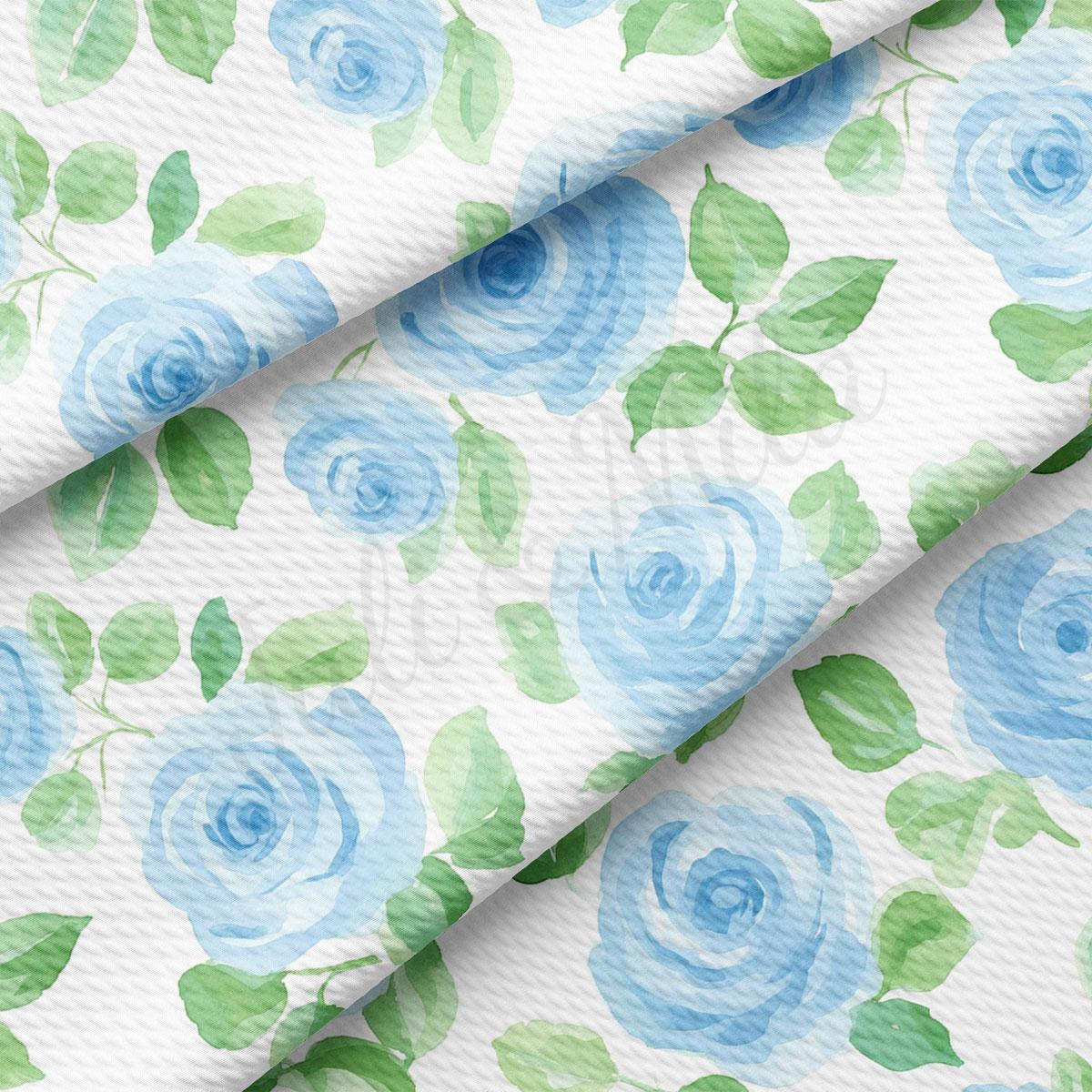 a repeating pattern of blue roses and green leaves on a white background.
