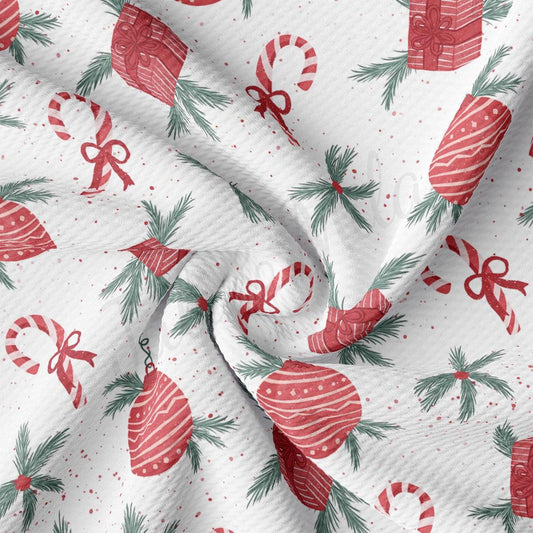 a white fabric with red and green christmas decorations