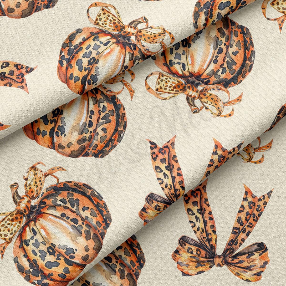 a repeating pattern of leopard print pumpkins with bows on a beige background.
