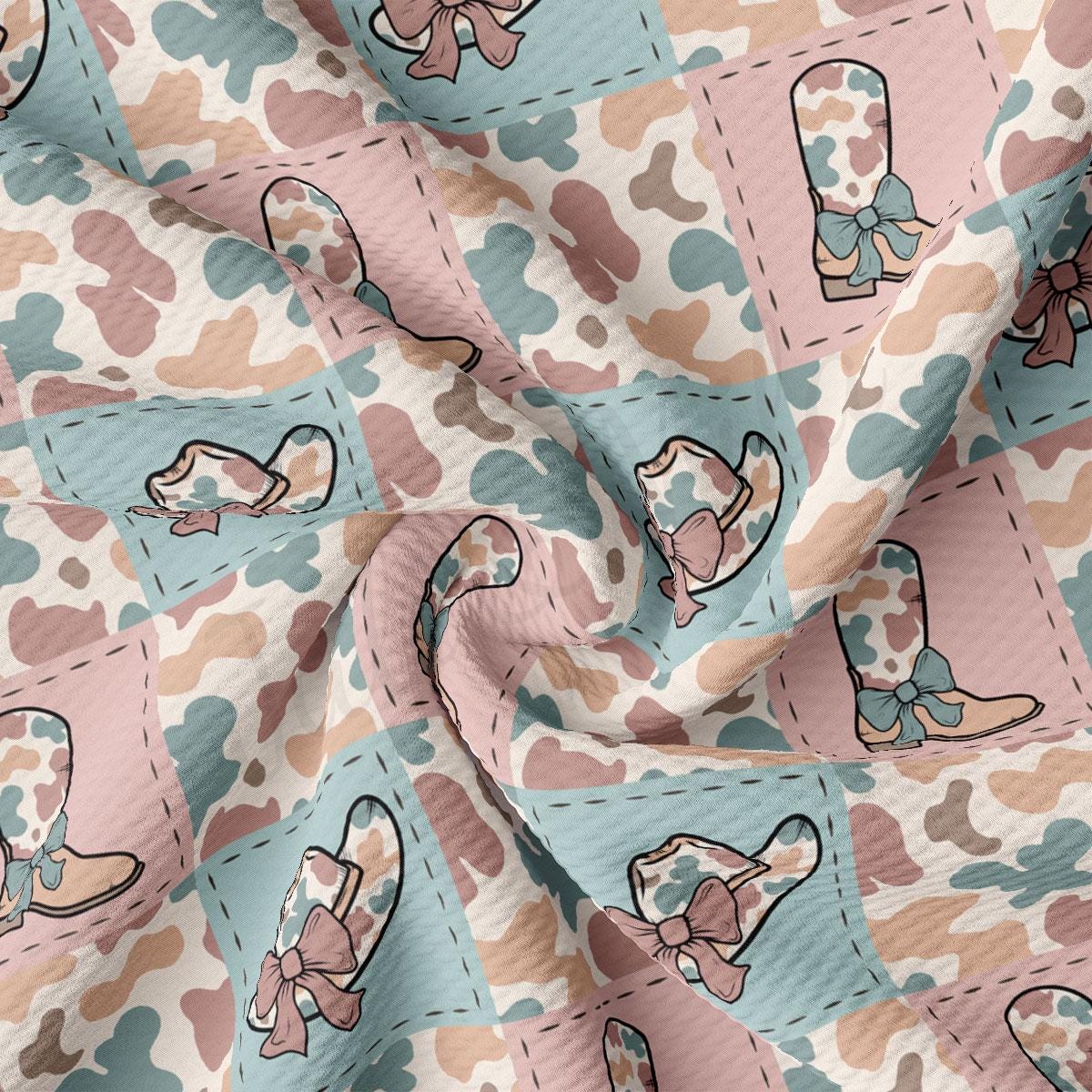 a pink and blue fabric with a pattern of baby booties