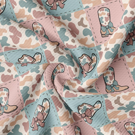 a pink and blue fabric with a pattern of baby booties