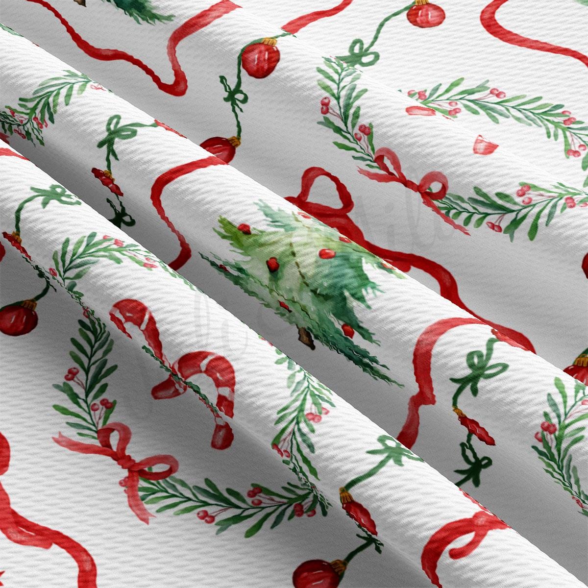 a close-up view of a fabric with a repeating pattern of Christmas-themed designs, including red and green elements such as trees, ribbons, and ornaments.