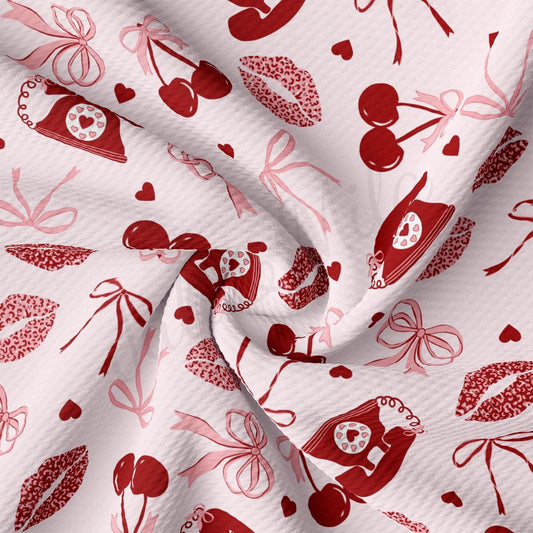 a red and white fabric with hearts and cherries on it