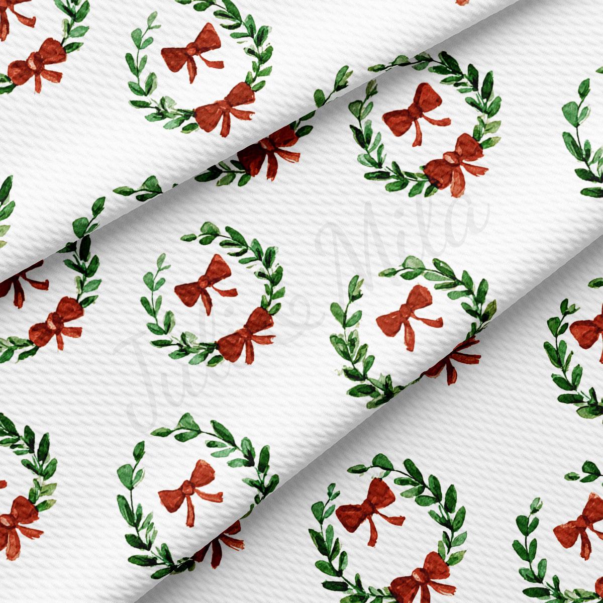 a repeating pattern of red bows and green leaves on a white background.