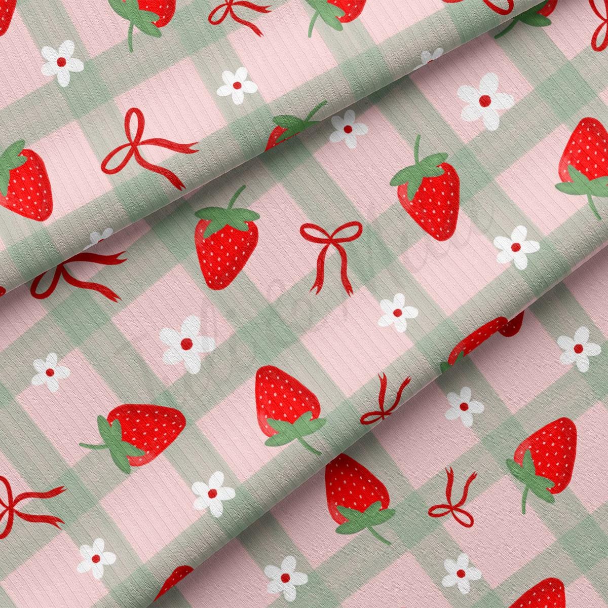 a pink and green checkered fabric with strawberries on it