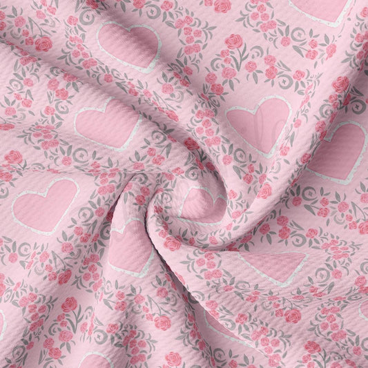a pink fabric with hearts and flowers on it