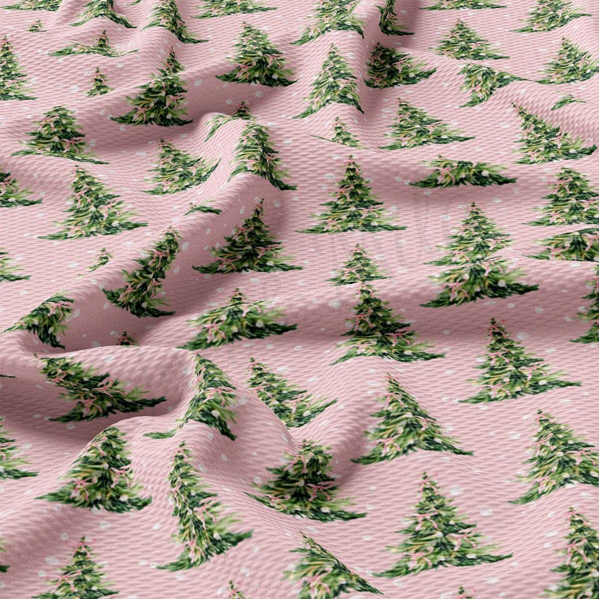 a repeating pattern of green Christmas trees on a pink background.