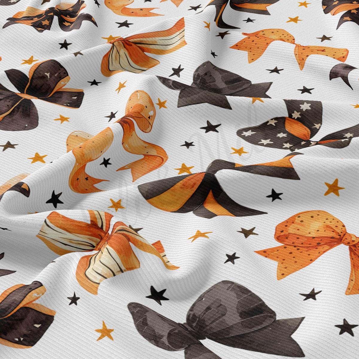 a close-up view of a fabric with a repeating pattern of orange and black bows, along with scattered stars.