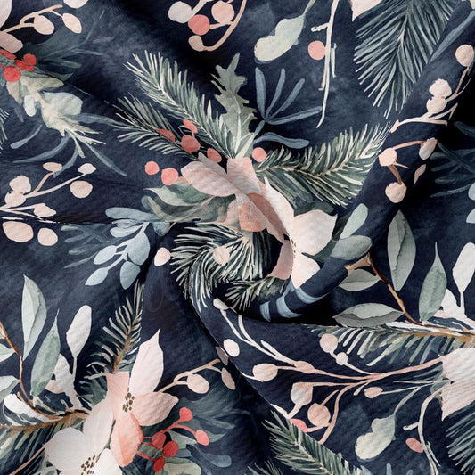 a close-up view of a fabric with a floral pattern. The fabric appears to be dark blue, with a mix of green, pink, and white floral elements. The pattern is intricate and detailed, showcasing the craftsmanship of the fabric.