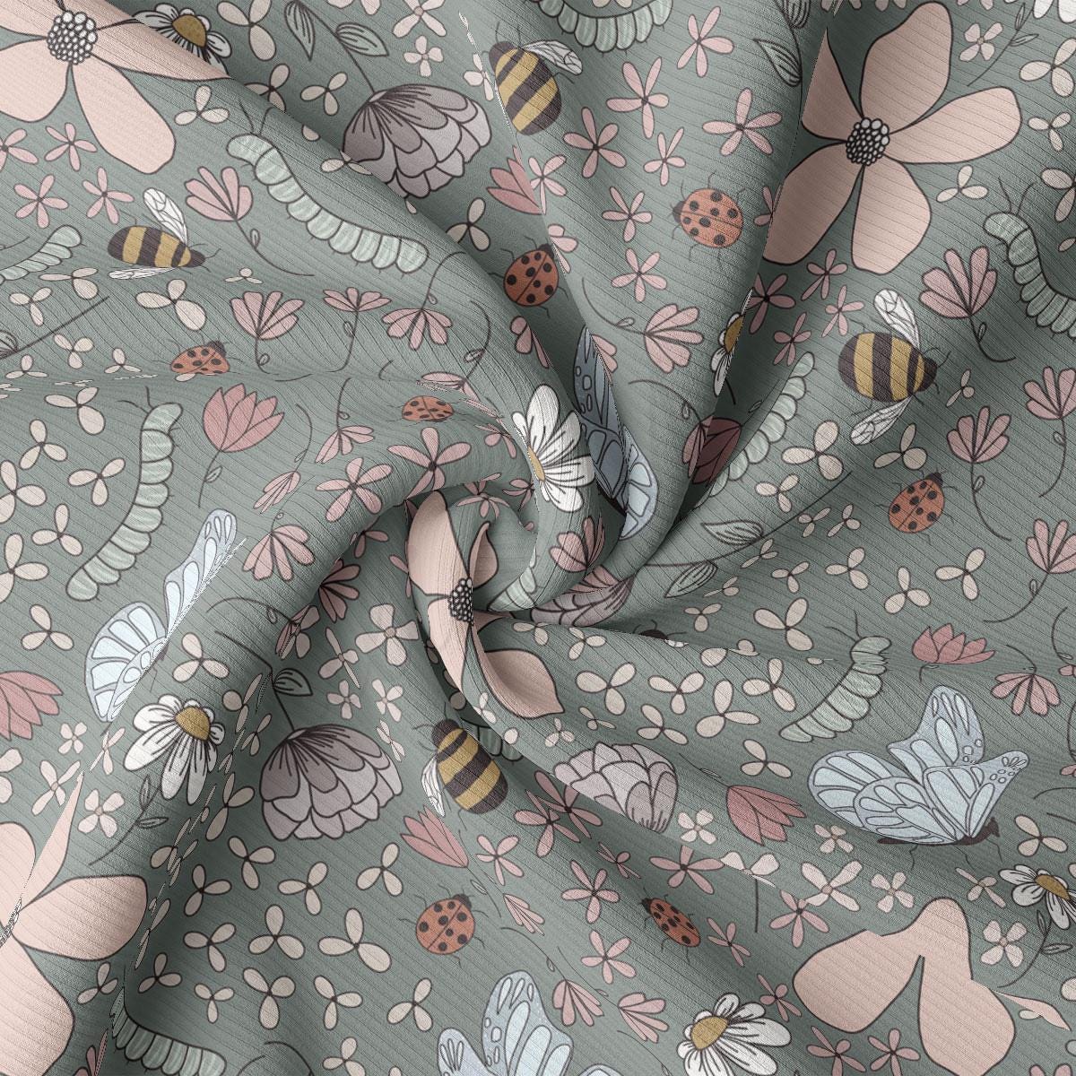 a close up of a fabric with flowers and bees on it