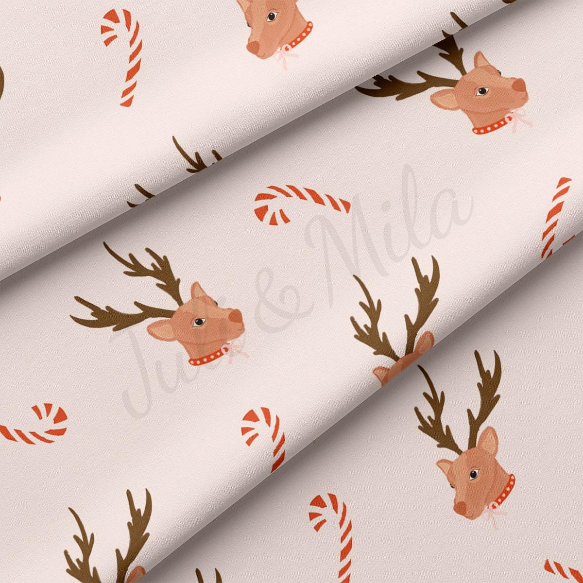 a pattern of reindeers and candy canes on a white background