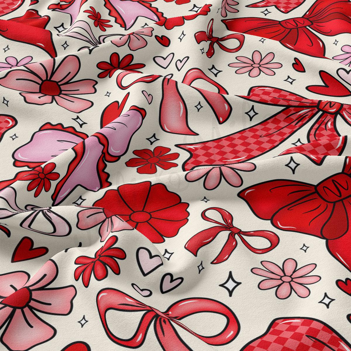 The image is a close-up of a fabric with a repeating pattern of red bows and flowers on a white background.