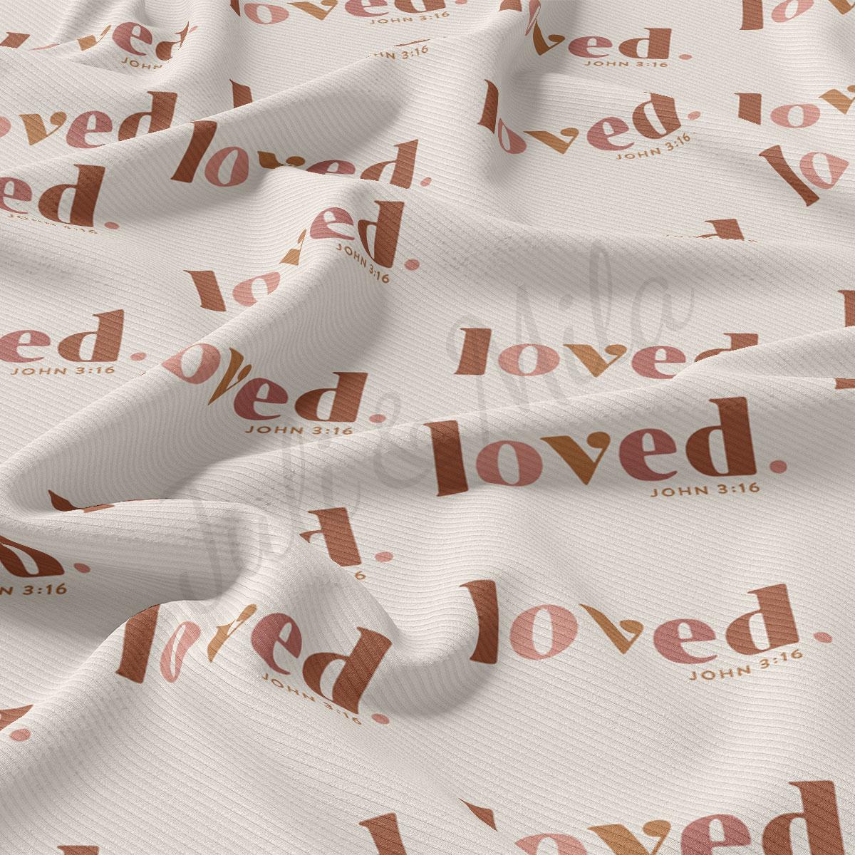 The image is a close-up of a fabric with a repeating pattern of the word "loved" in a brown color.