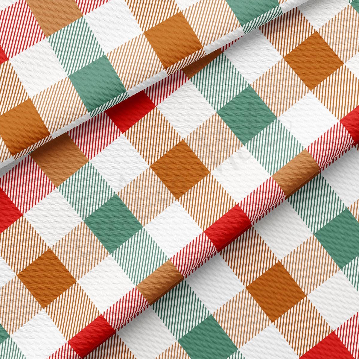 a close-up view of a fabric with a repeating pattern of red, white, and green squares, creating a checkered design.