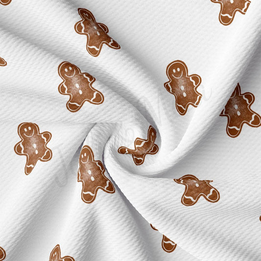 a close up of a white fabric with ginger cookies on it
