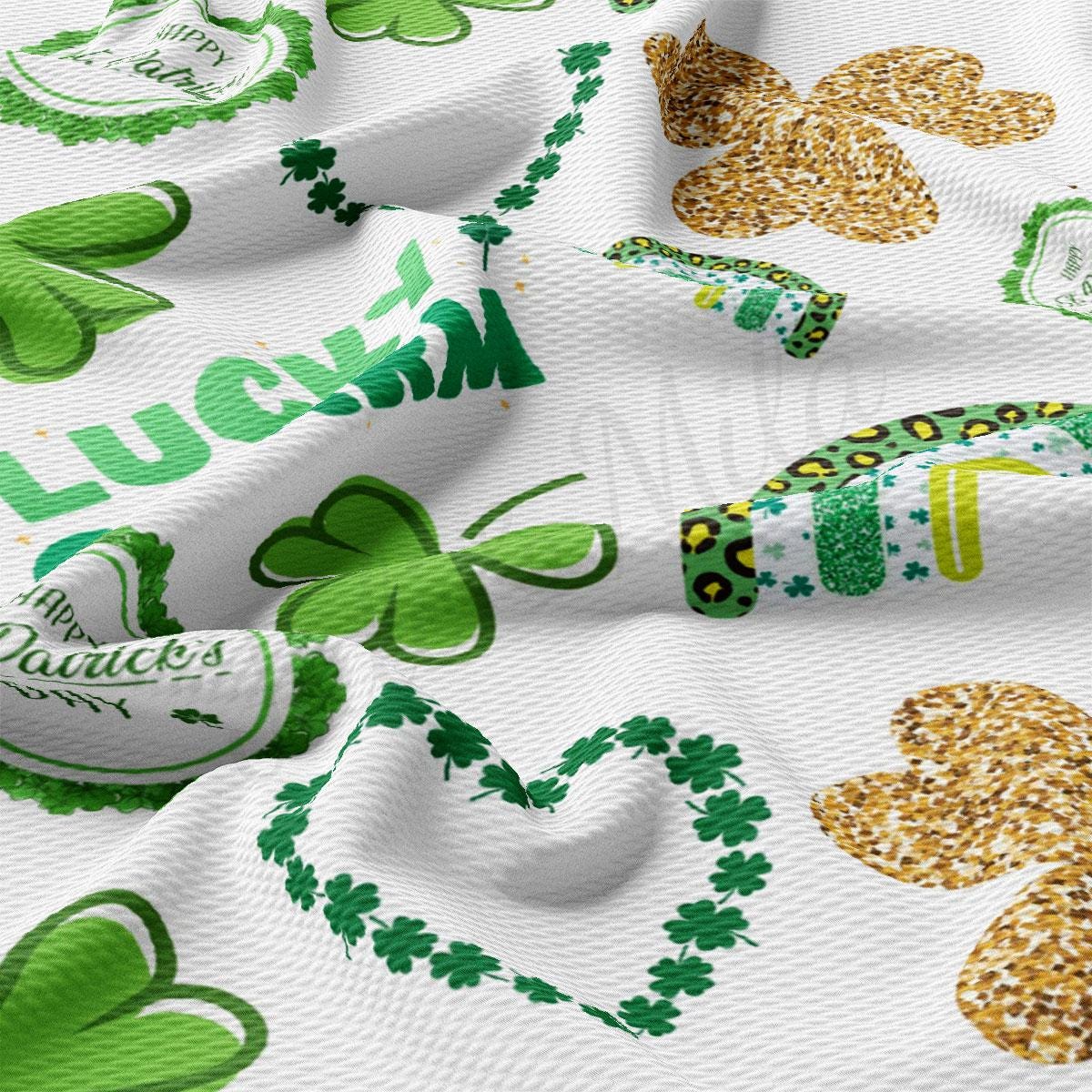 a close up of a white fabric with shamrocks on it