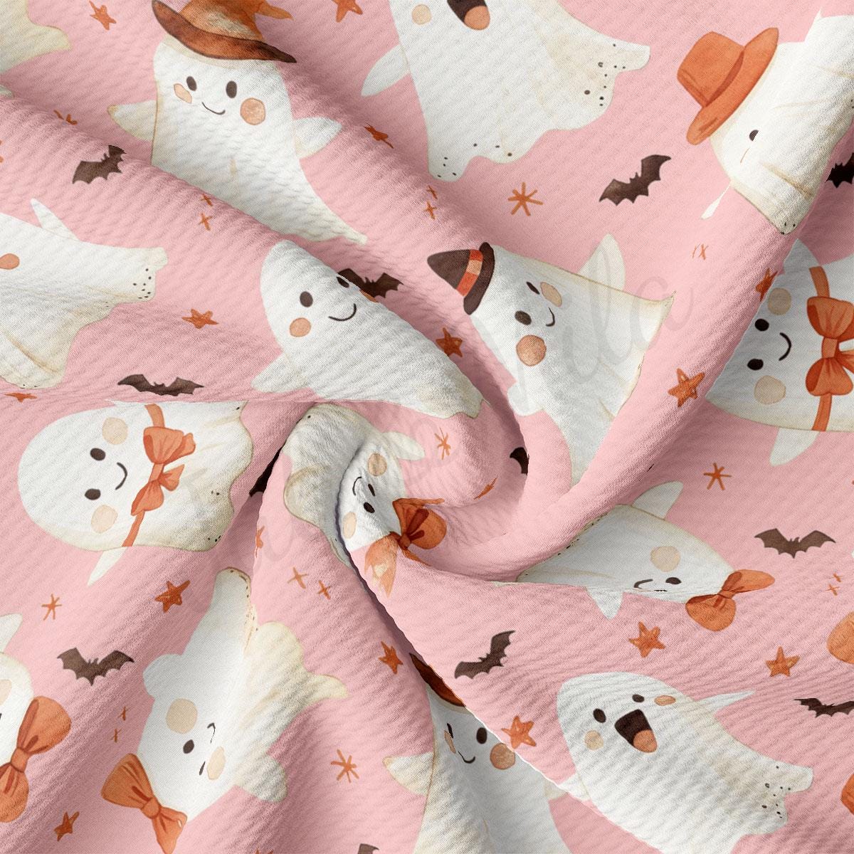 a close-up view of a fabric with a repeating pattern of white ghost characters, some wearing hats and bow ties, against a pink background with stars and bats.