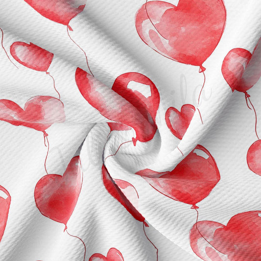 a close-up view of a fabric with a repeating pattern of red heart-shaped balloons floating against a white background.