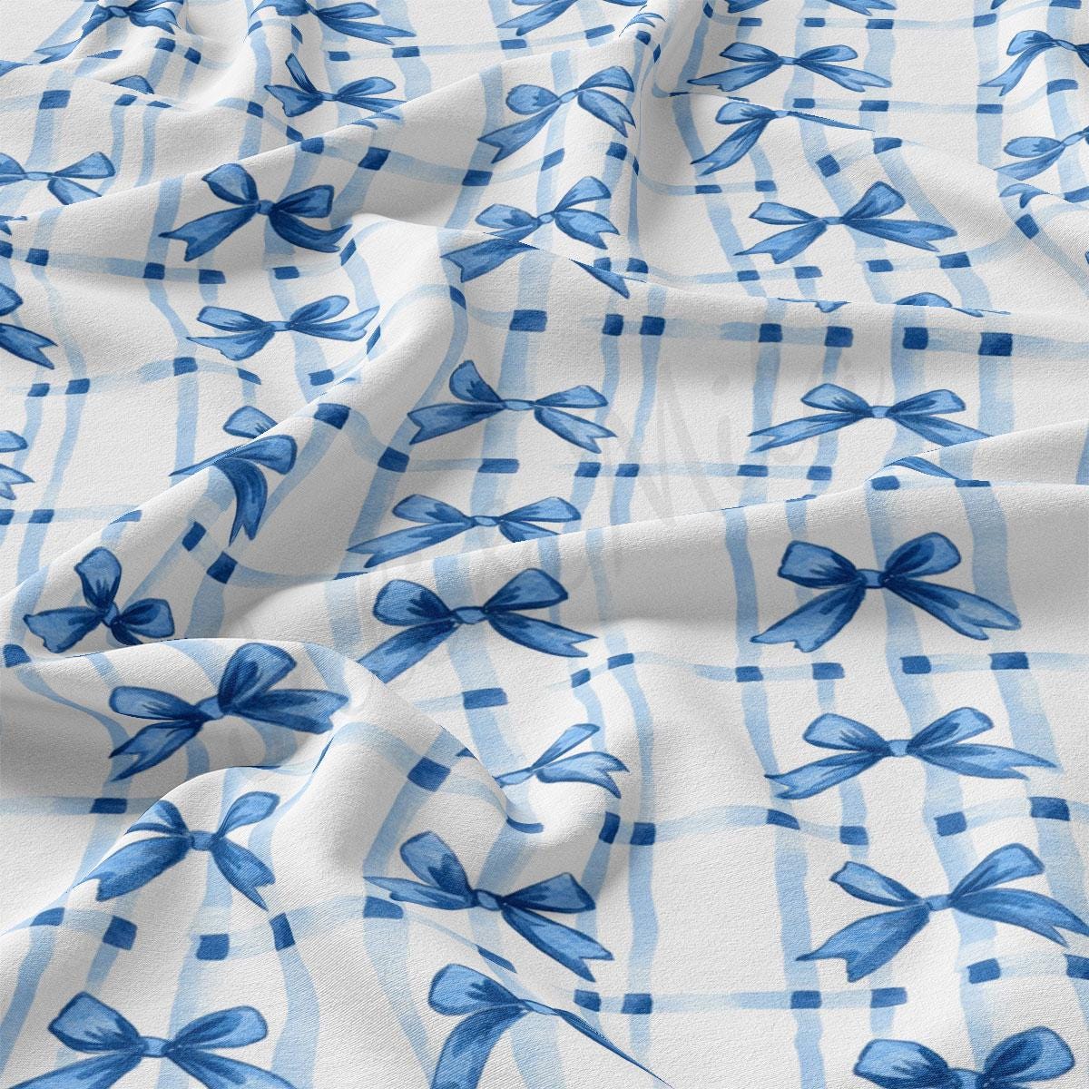 a blue and white checkered fabric with bows