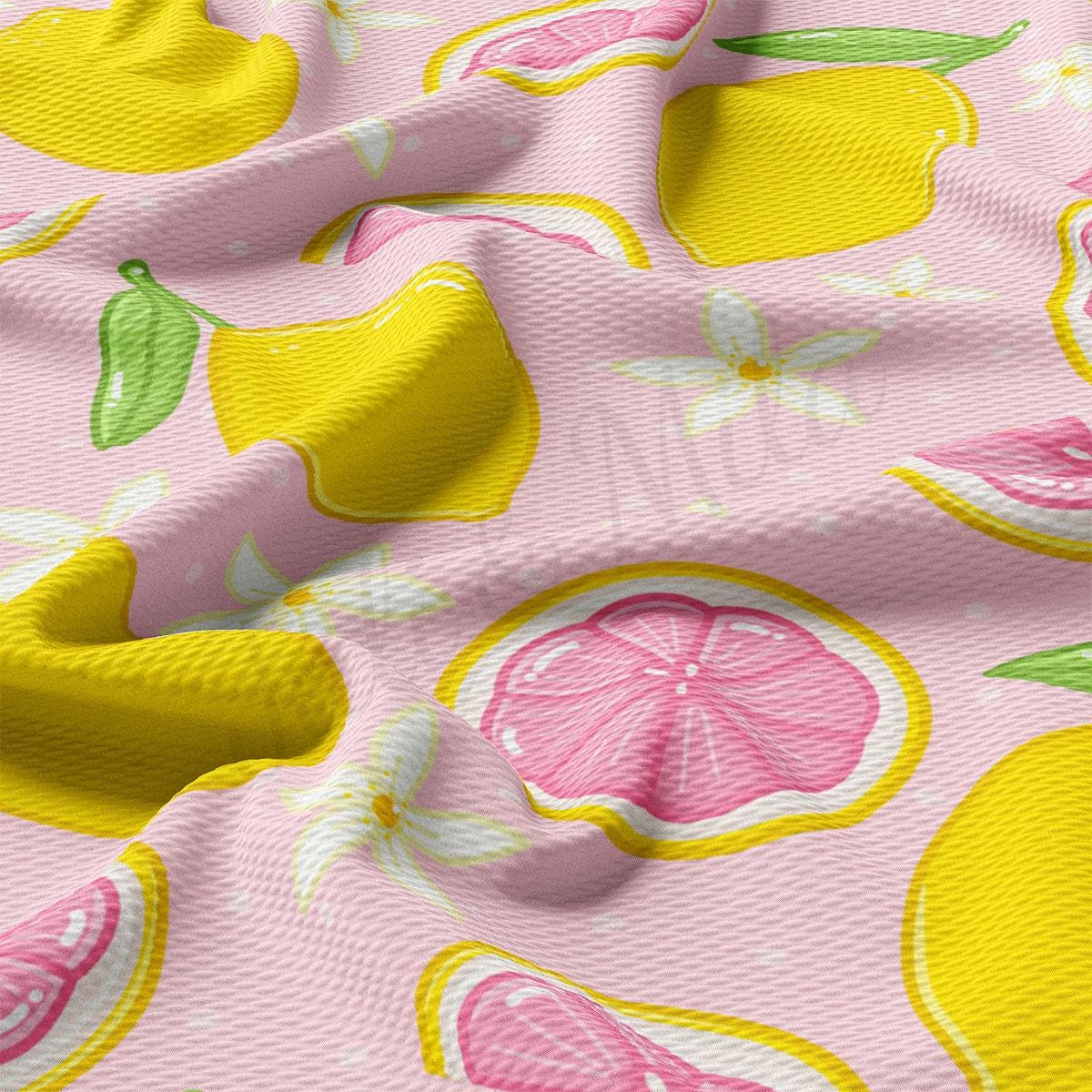 a pink and yellow fabric with lemons on it