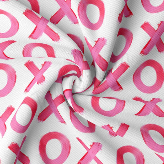 a white and pink fabric with pink letters on it