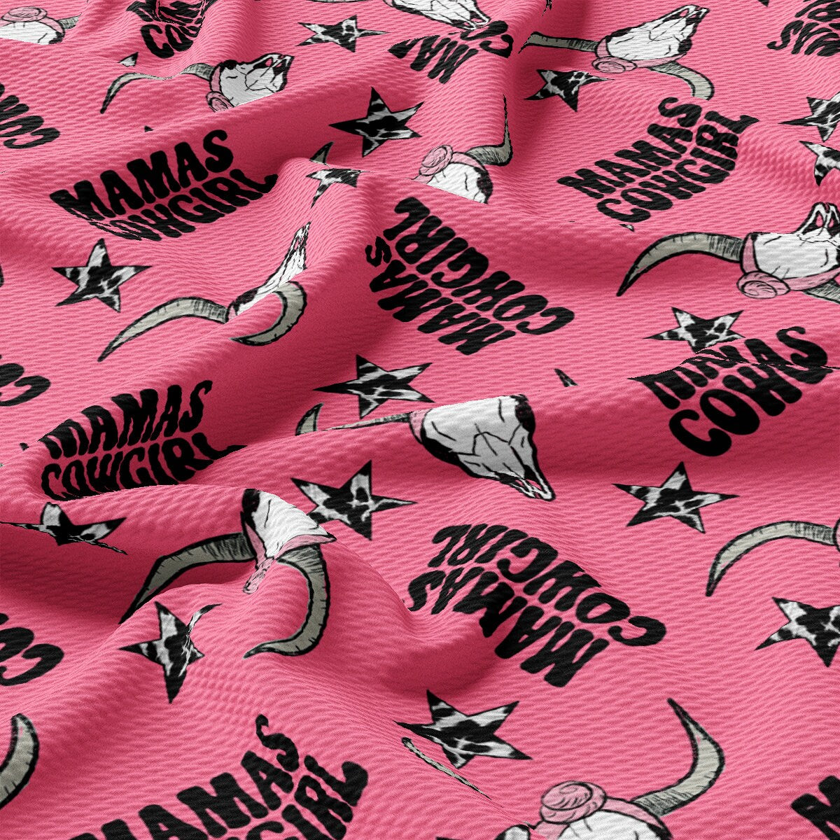 a pink fabric with black and white images on it