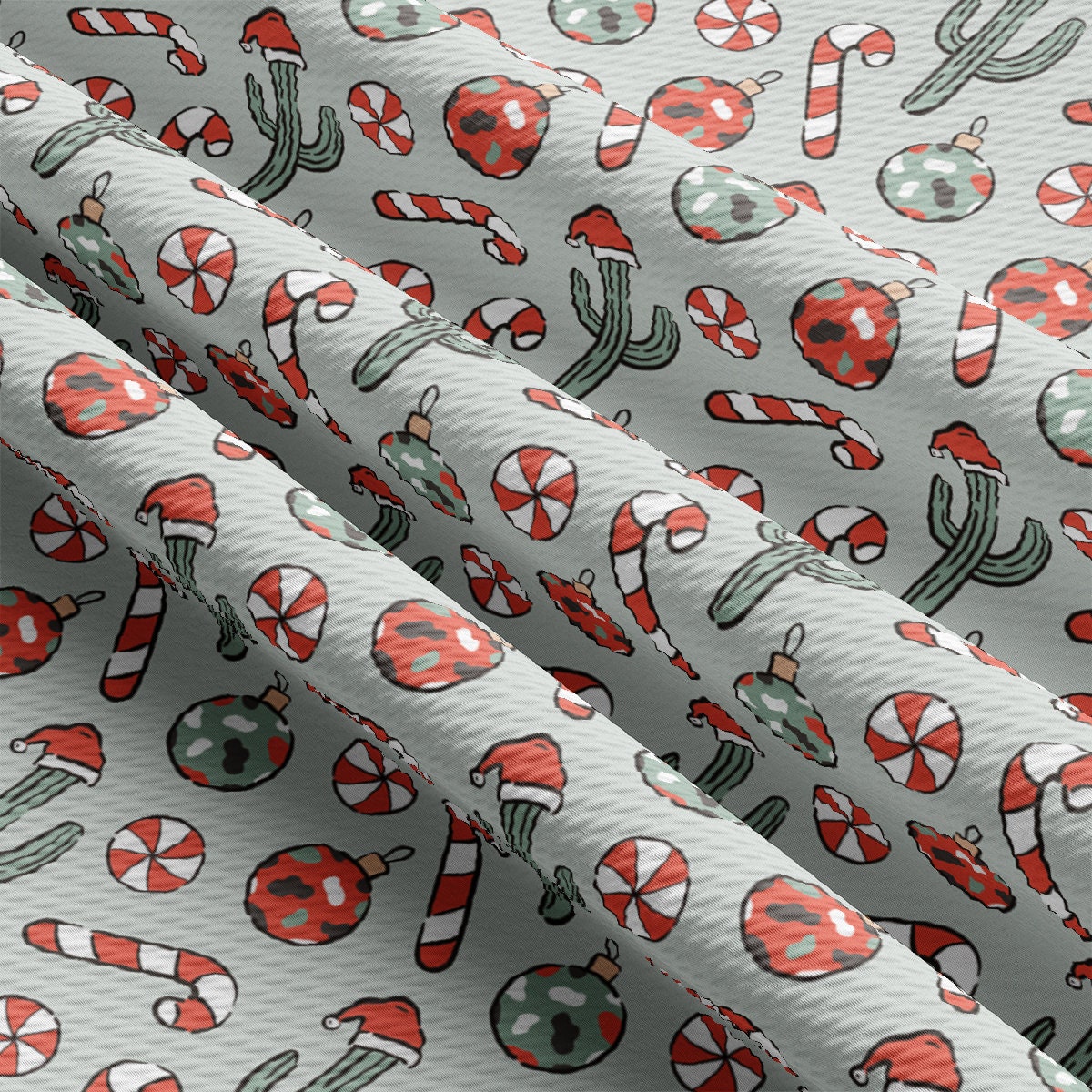 a close up of a white fabric with red and green designs