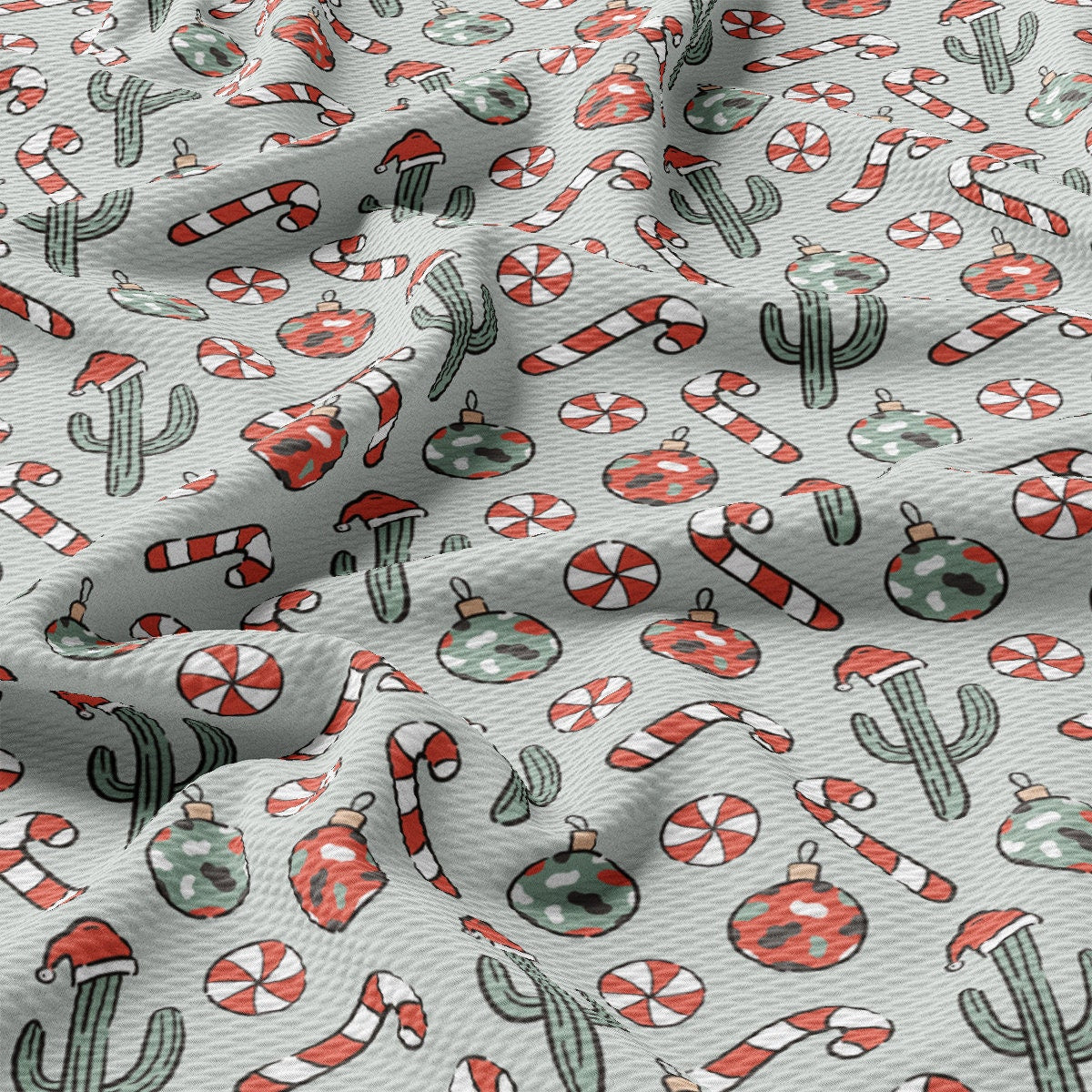 a close up of a white fabric with red and green designs