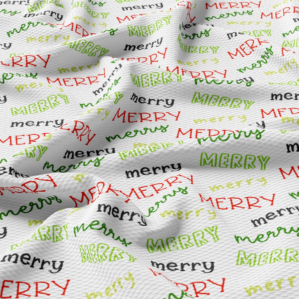 a close up of a white fabric with merry lettering