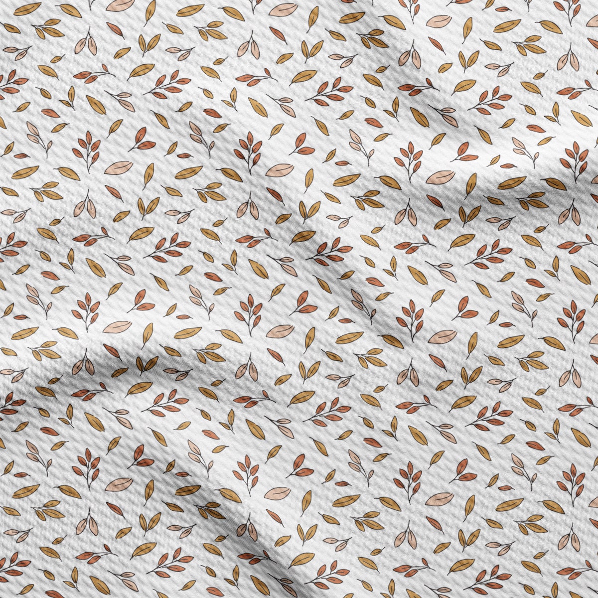 a white sheet with brown leaves on it