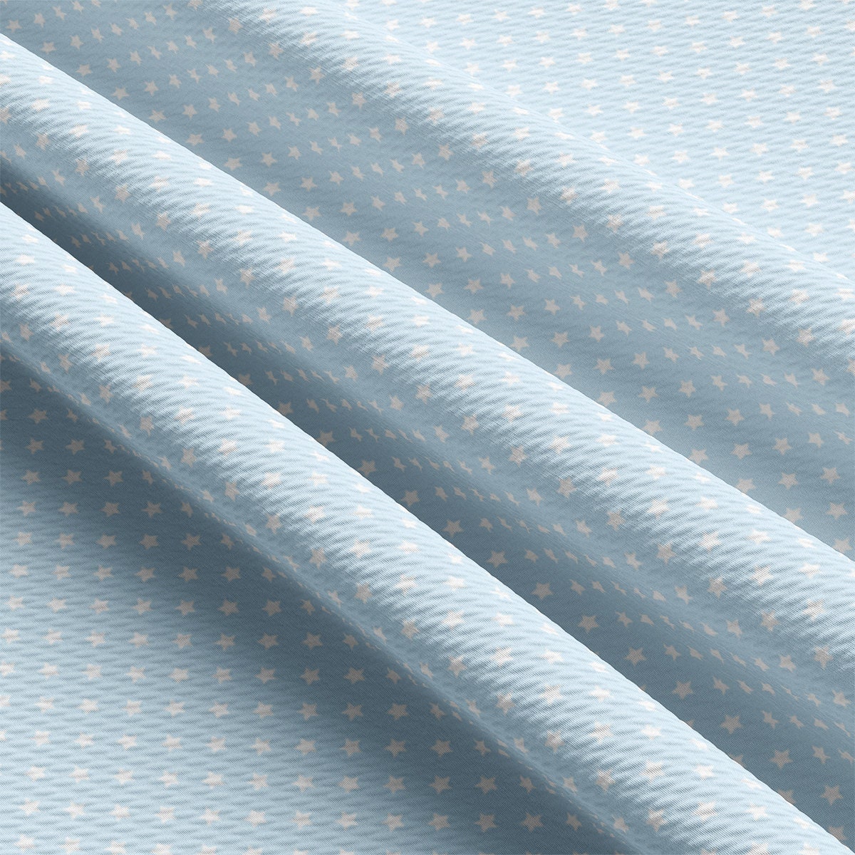 a close up of a light blue fabric with gold stars