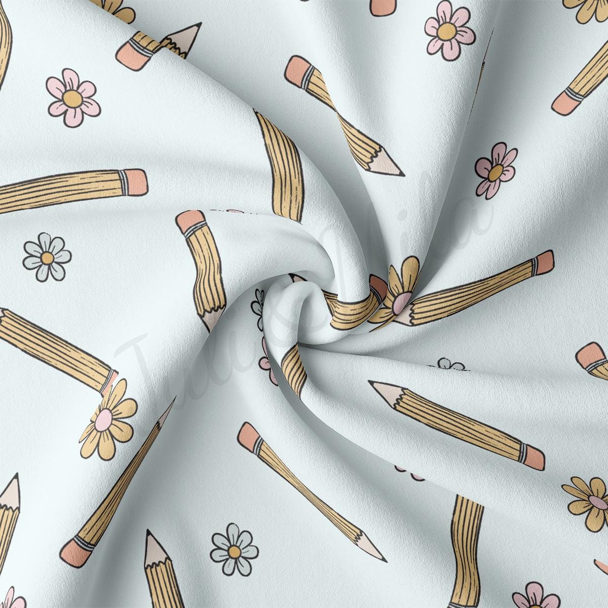 a white fabric with pencils and flowers on it