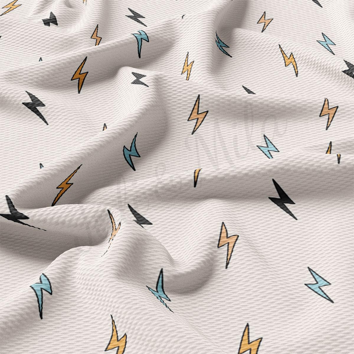 a close up of a white fabric with lightnings on it