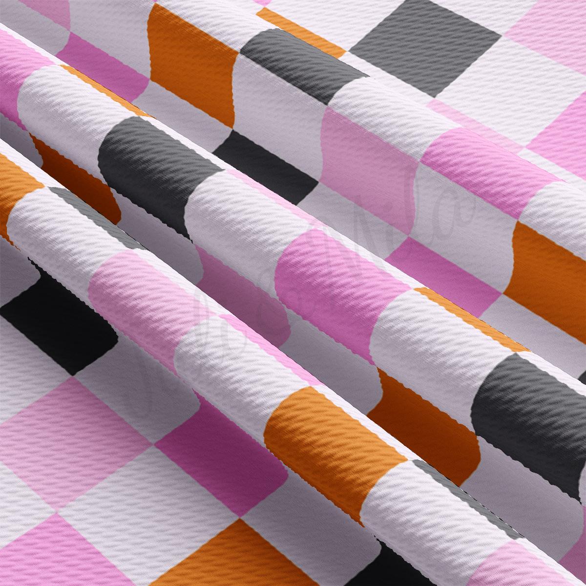 a close up of a pink and black checkered table cloth