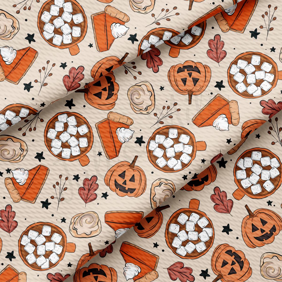 a close up of a pattern of pumpkins and marshmallows