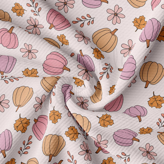 a close up of a white fabric with leaves and acorns on it