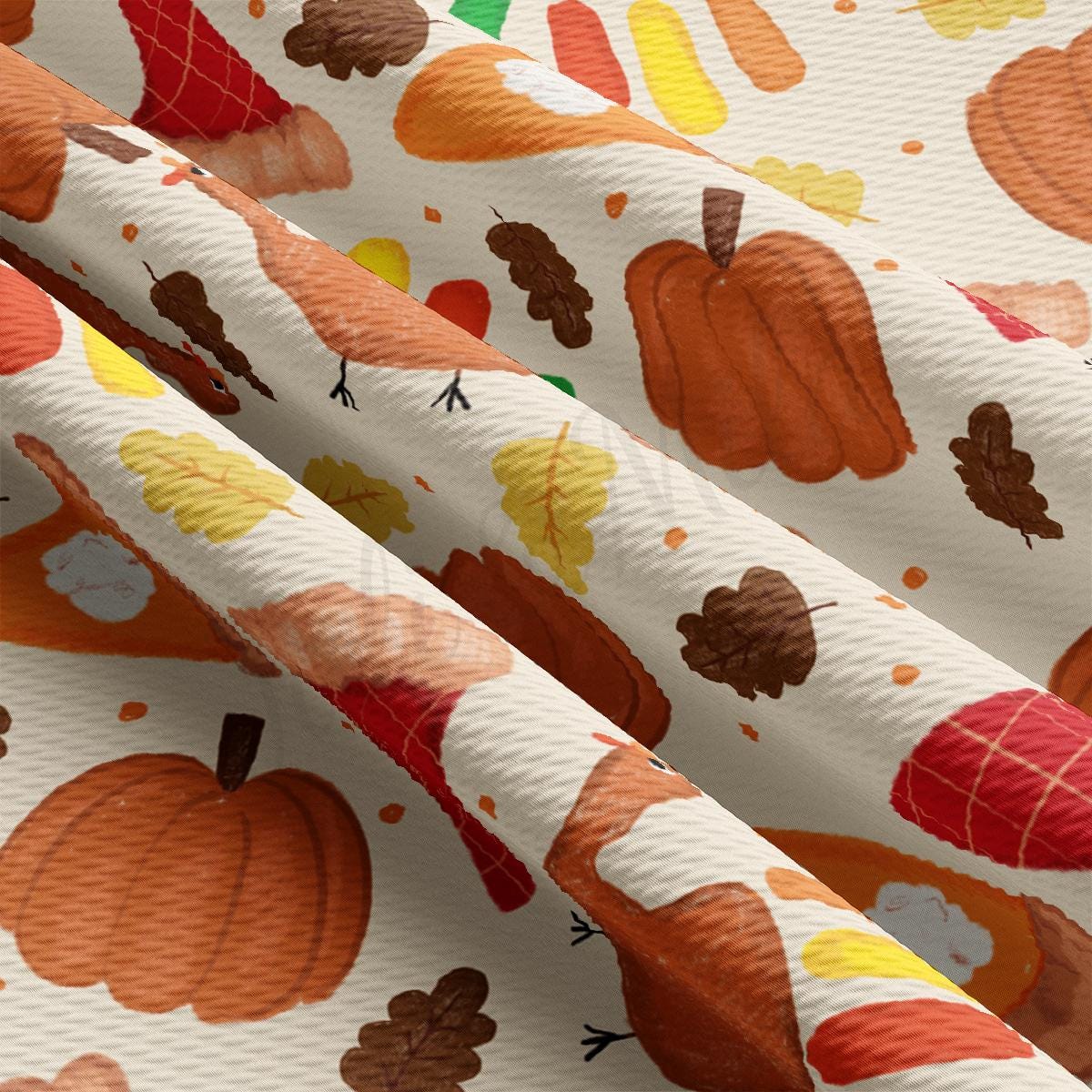 a close up of a white fabric with a pattern of pumpkins and leaves