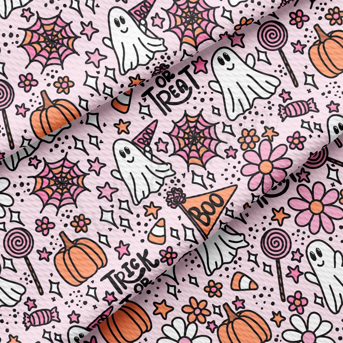 a pink background with a pattern of halloween decorations